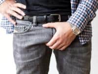 Guy grabbing his crotch