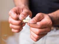 Man opening a condom